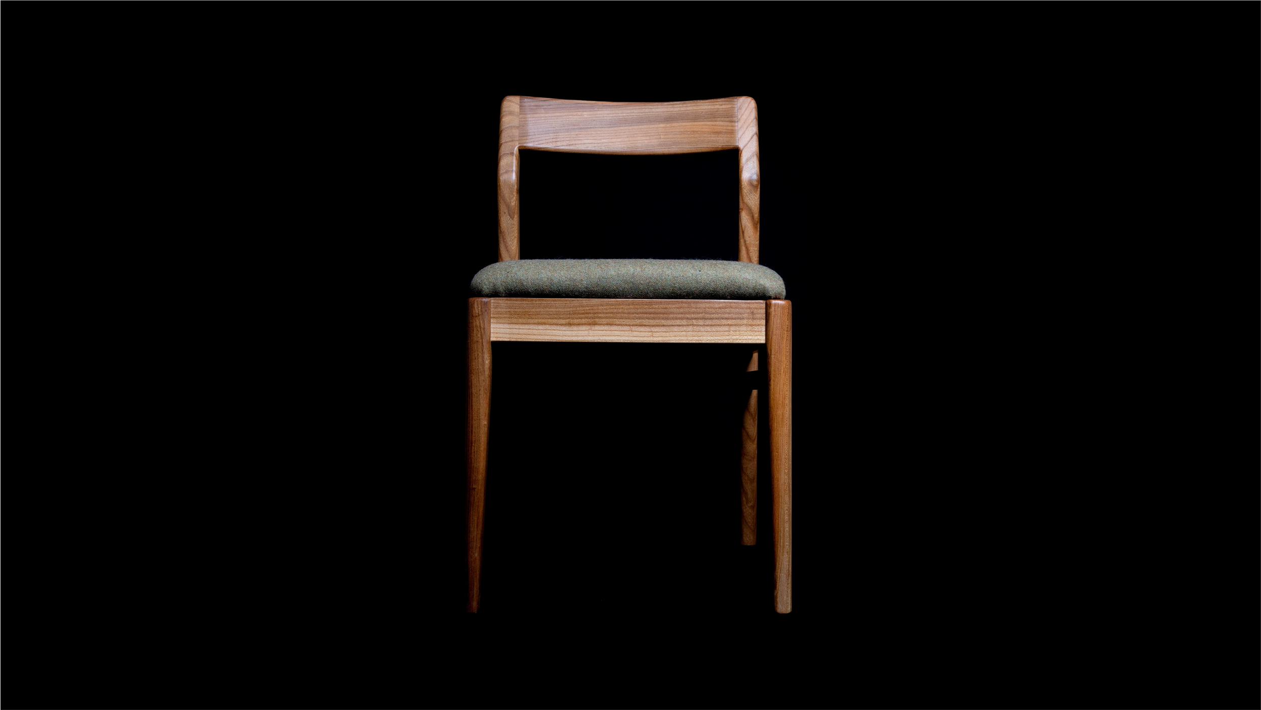 lternative front angled view of Clava Dining Chair in elm.