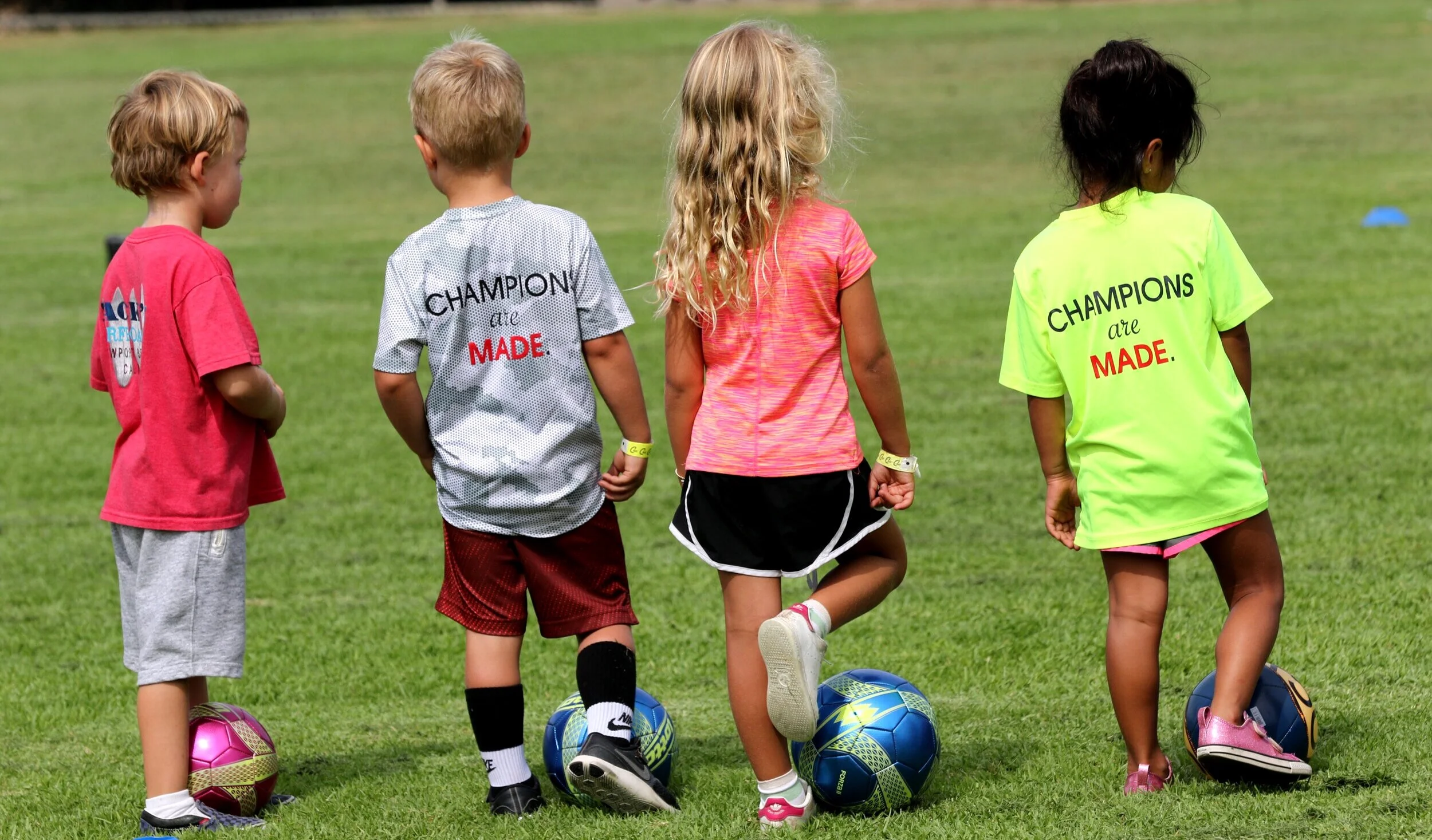 Preschool kids preparing for soccer camp activity