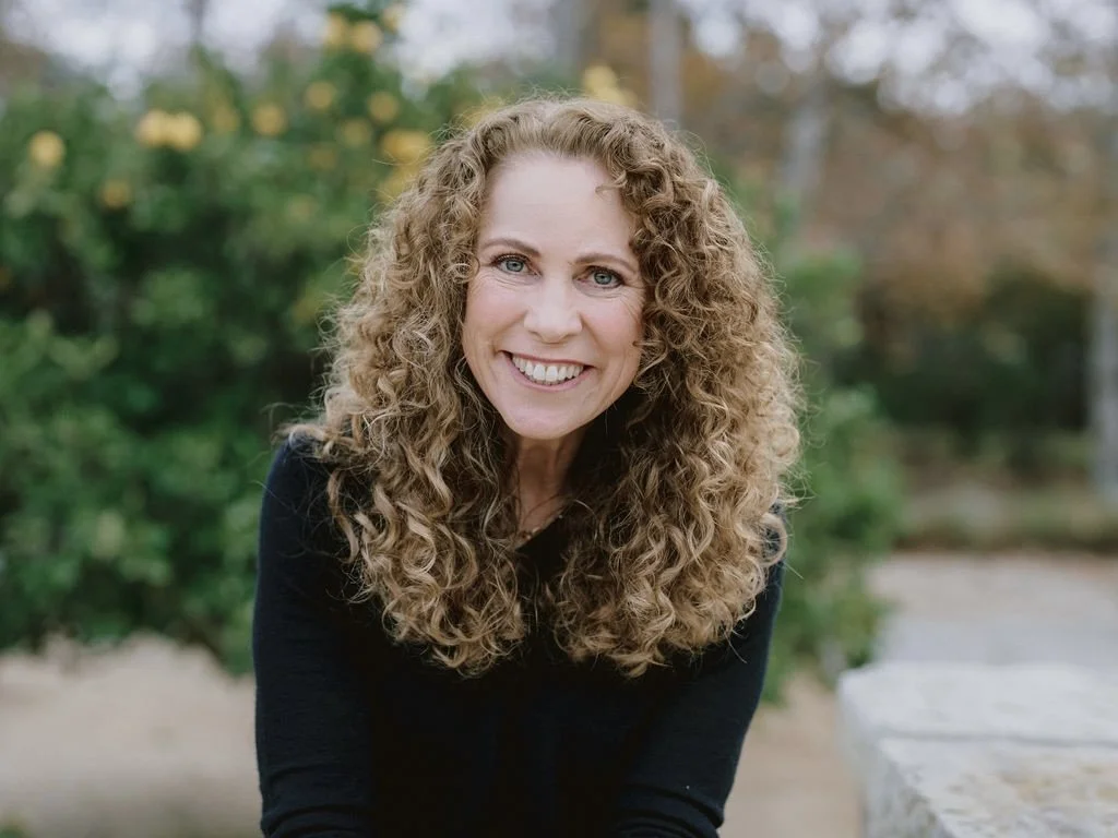 Parenting coach Jeanine Mouchawar smiling outdoors, helping parents who feel like every conversation with their teen turns into an argument