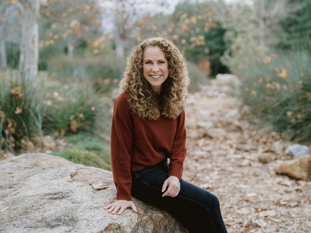 Parenting expert Jeanine Mouchawar smiling outside, helping parents reduce conflict and rebuild connection with their teen.