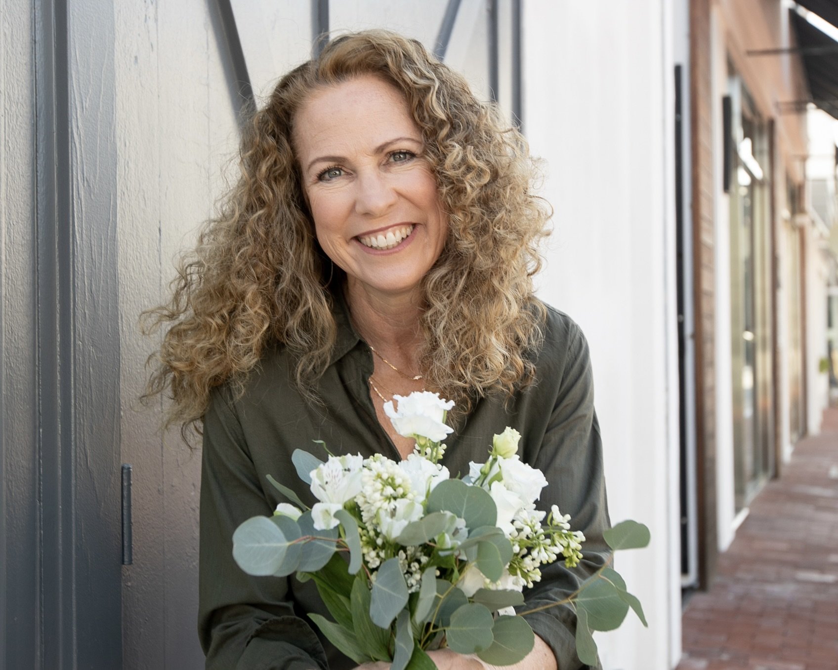 mom holding flowers on Mother’s Day feeling unappreciated after a tense moment with her teenager