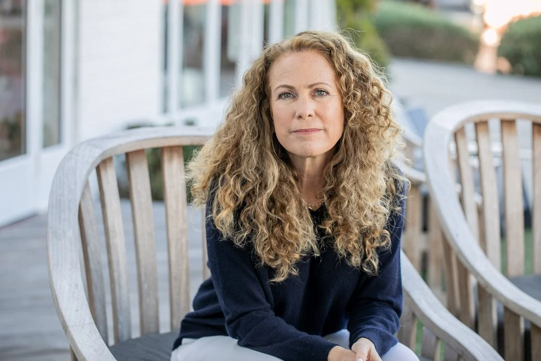 Parenting coach Jeanine Mouchawar seated outdoors, looking calmly at the camera, representing guidance for parents feeling stuck in repeated conflicts and communication patterns with teenagers.