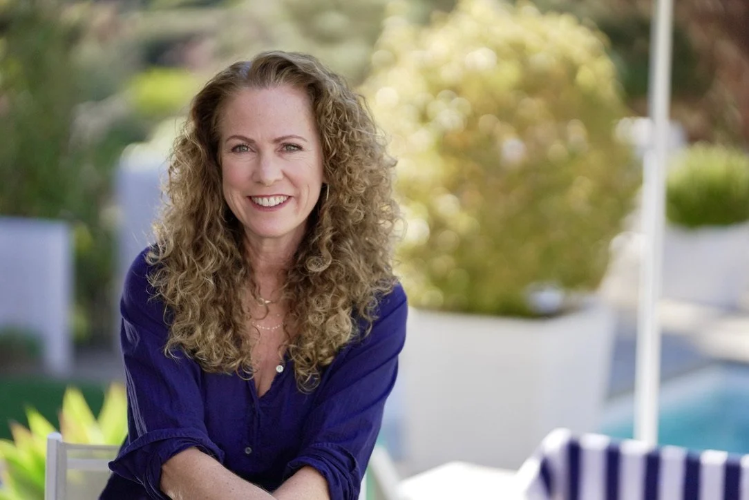 Parenting coach Jeanine Mouchawar smiling outdoors, specializing in helping parents improve communication and connection with teenagers.