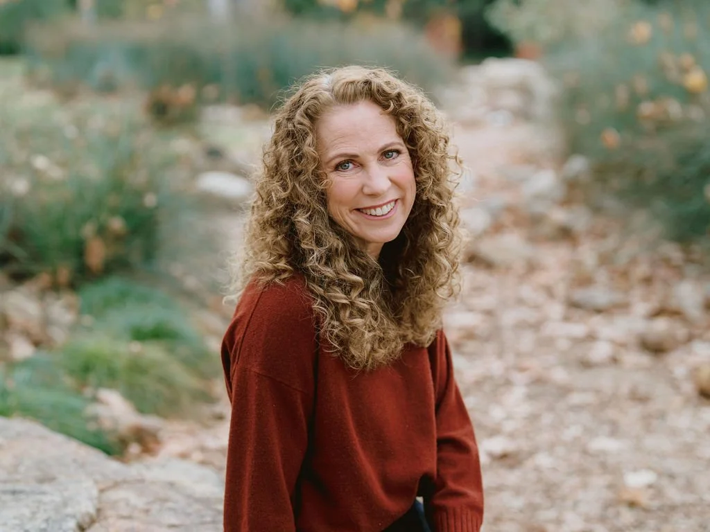 Parenting coach Jeanine Mouchawar smiling warmly outdoors, offering support for parents who feel disconnected from their teen