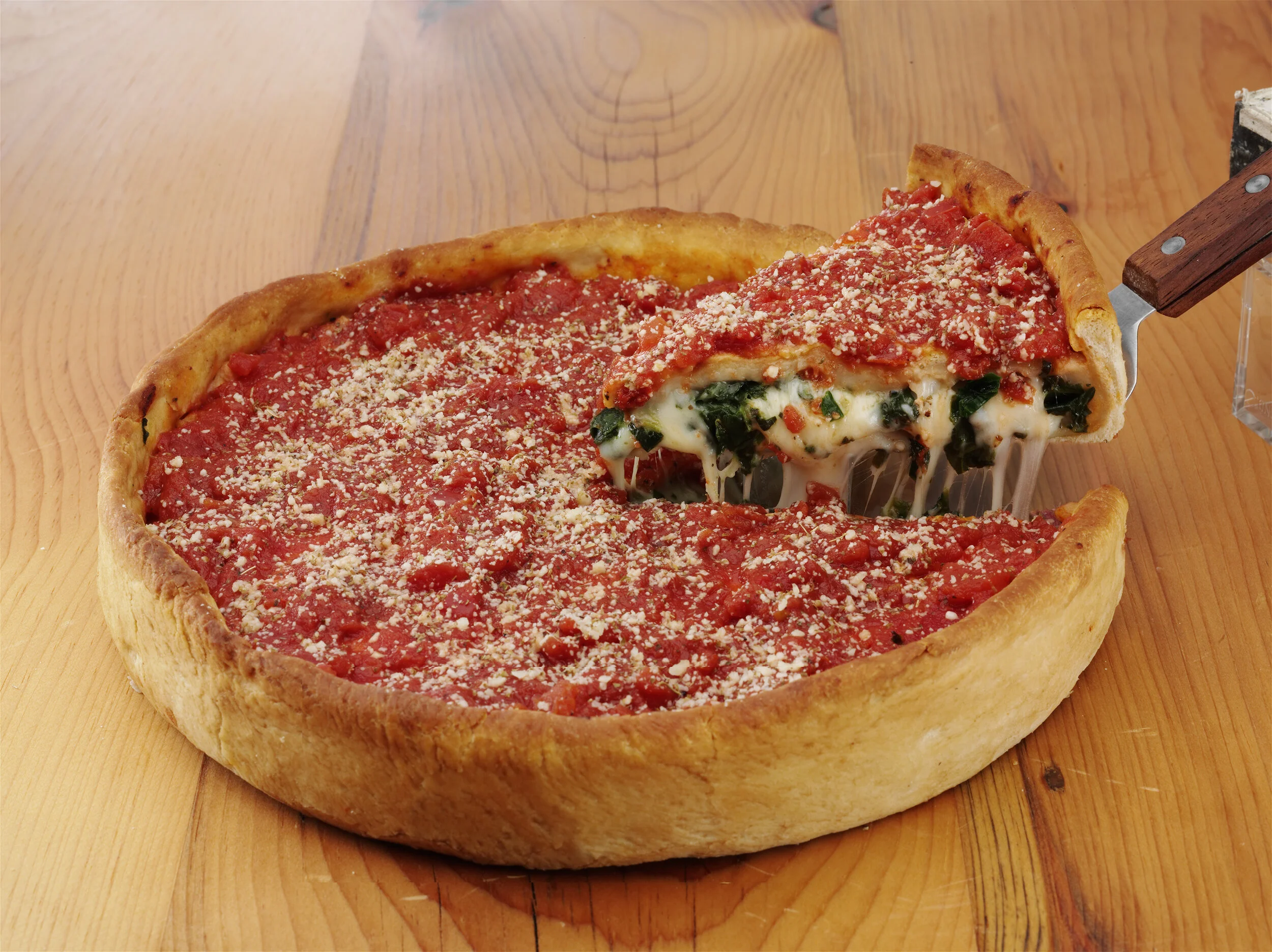 Edwardo's signature deep dish stuffed spinach pizza with melted cheese pull.jpg