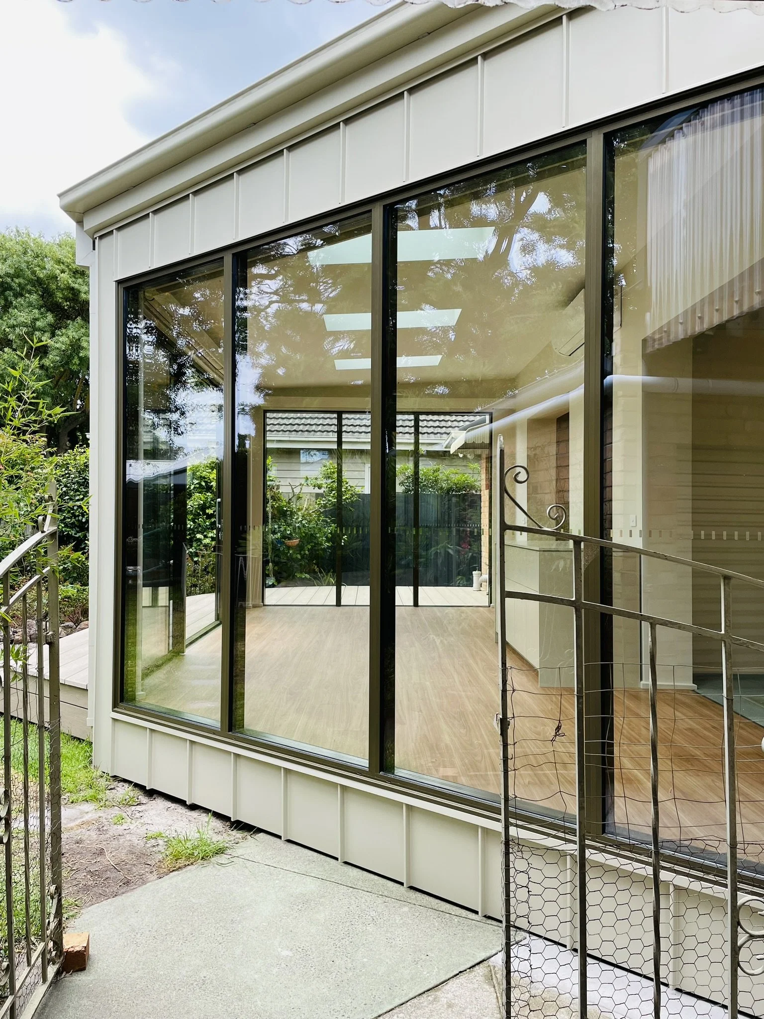 Angled wall view as you open the gate to come in to the backyard.