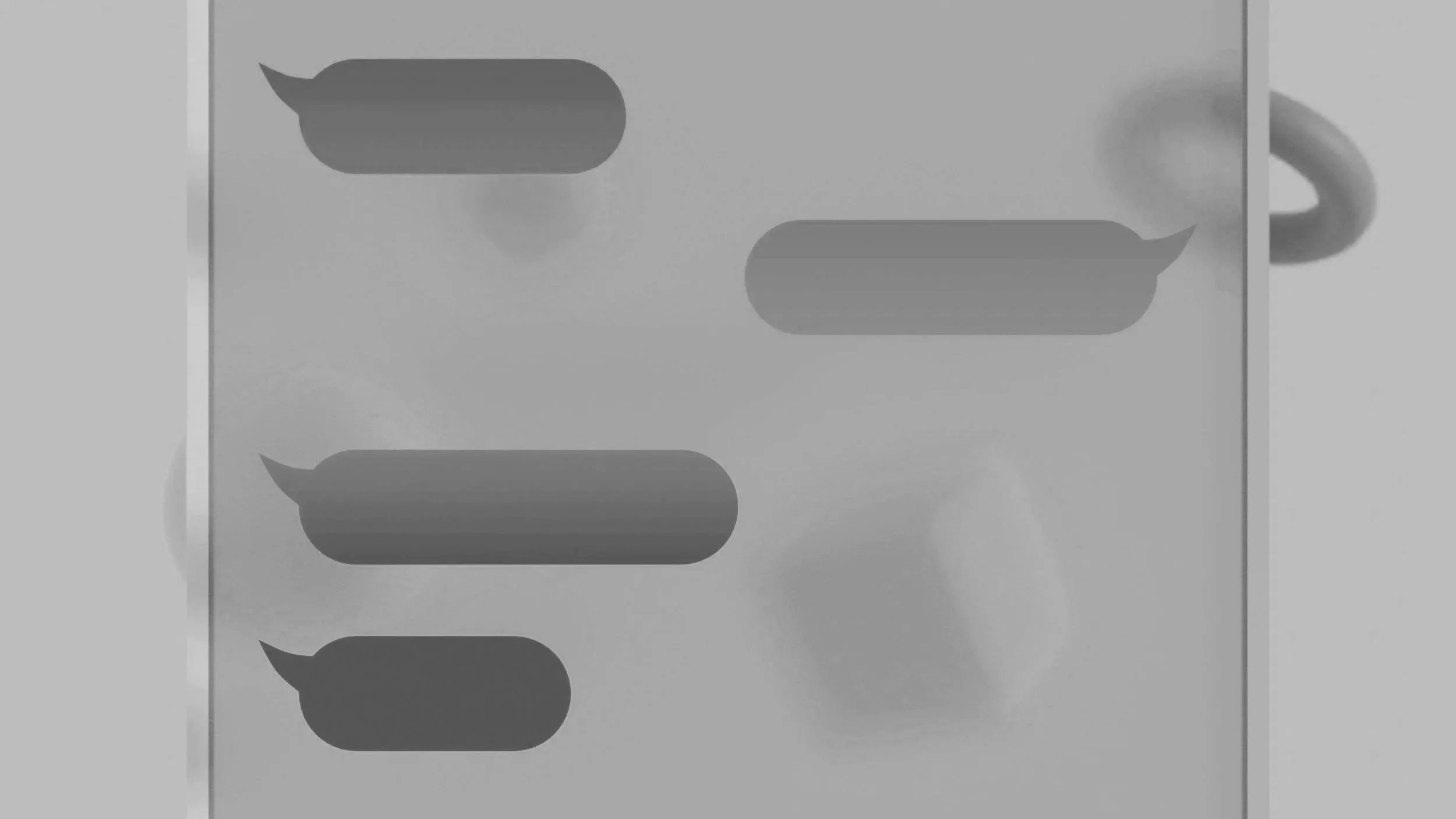 A grayscale photo of a smartphone screen displaying a conversation with three speech bubbles.