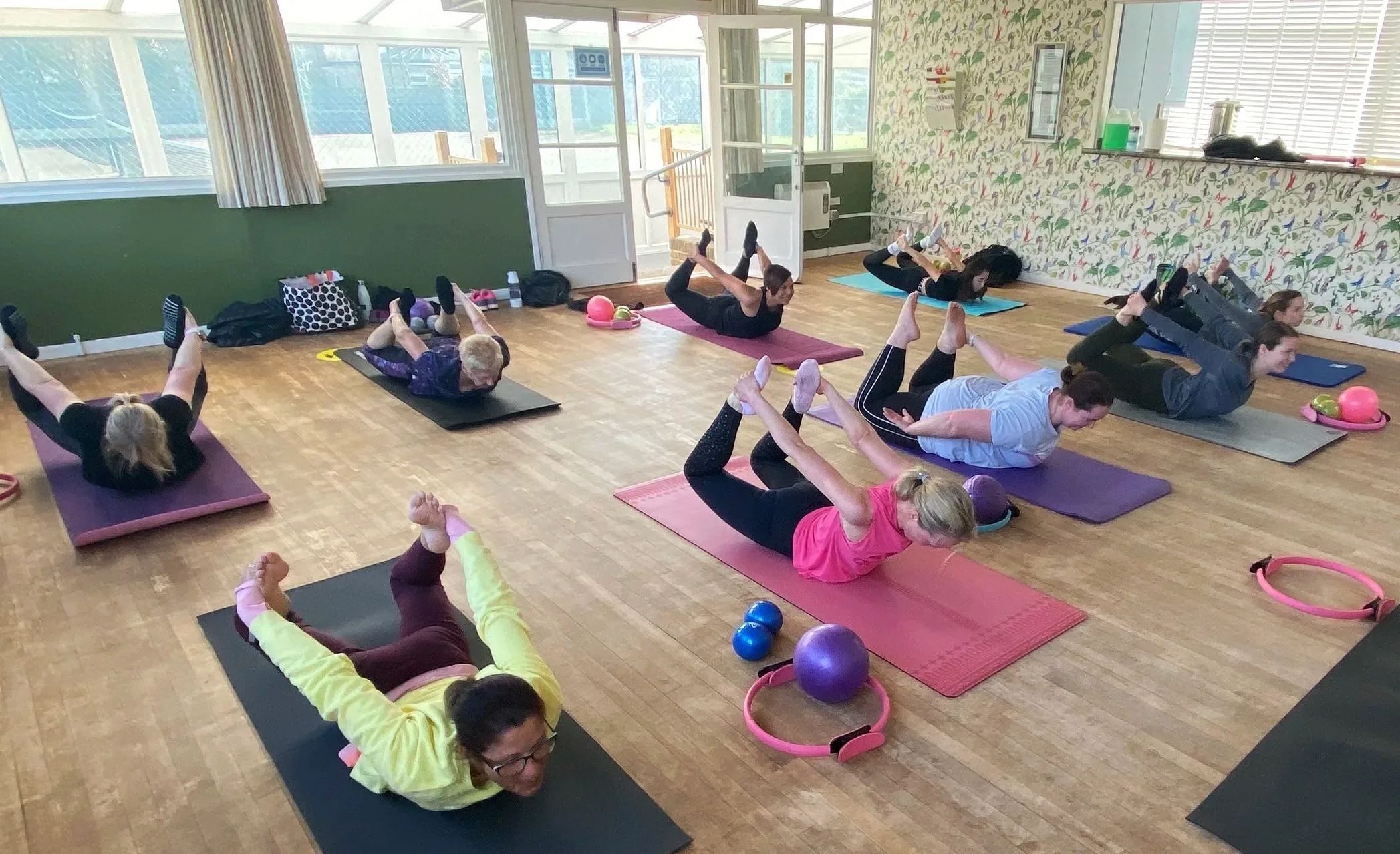 Pilates mat classes classes in Raynes Park studio with ladies practicing pilates techniques.