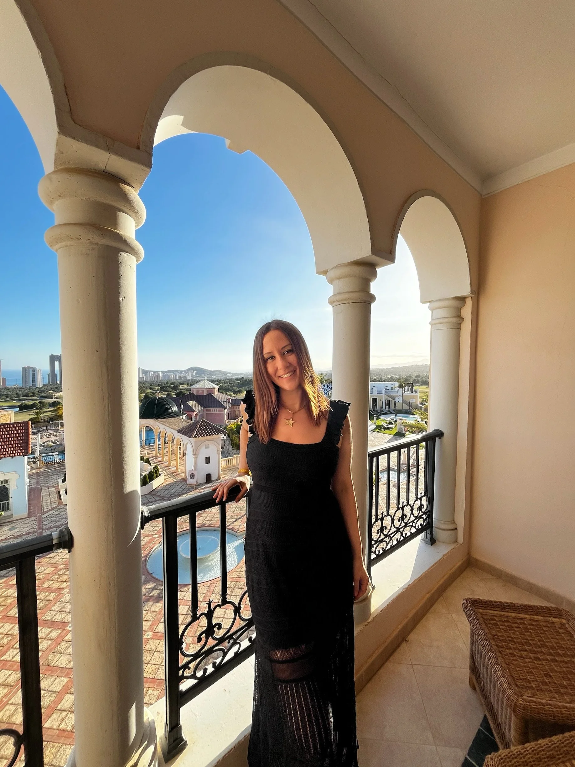 Pilates teacher in Spanish Pilates Retreat with a pool and mountains in the background