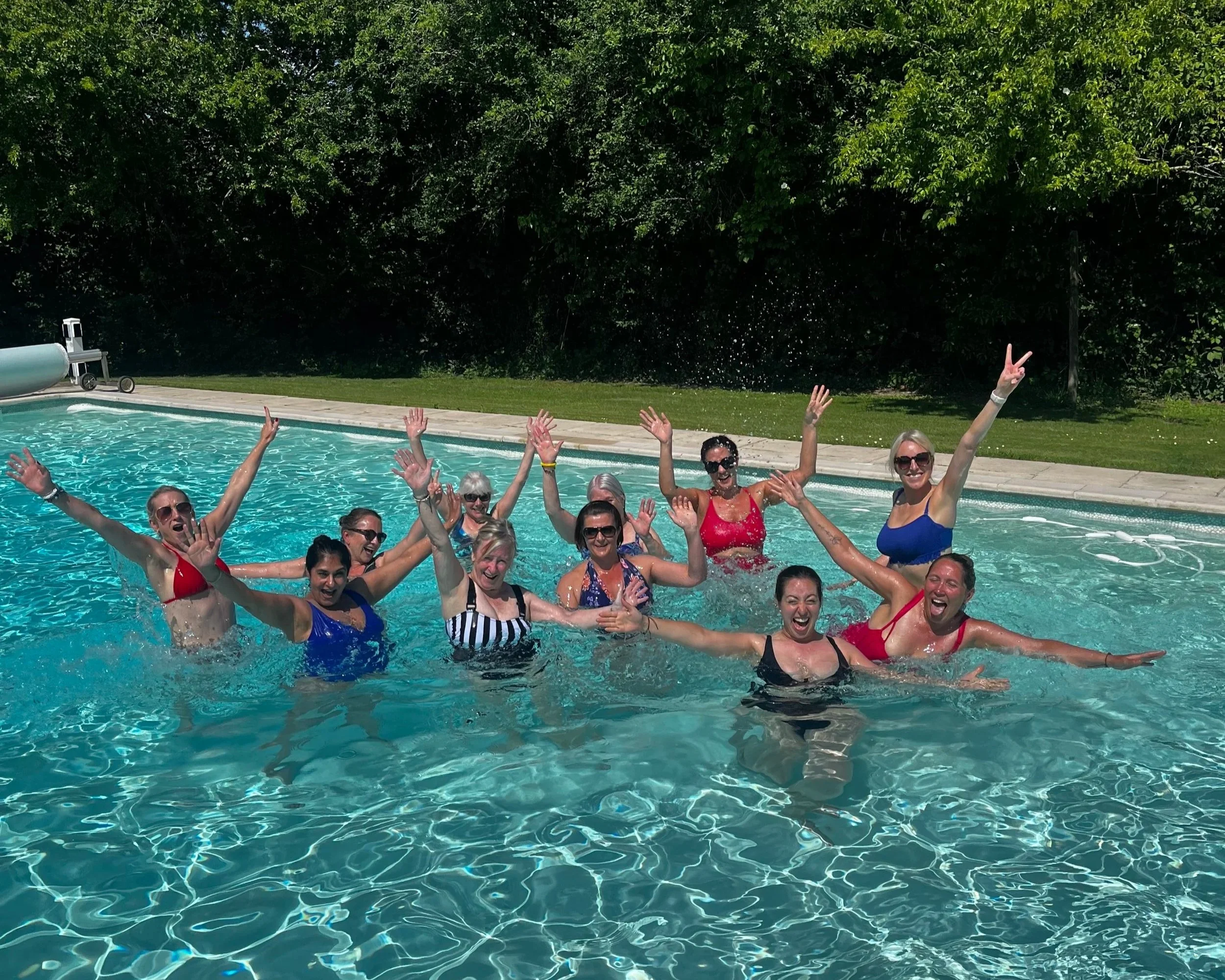 Ladies on a french trip to a Pilates Retreat in South of France in a swimming pool in sunshine