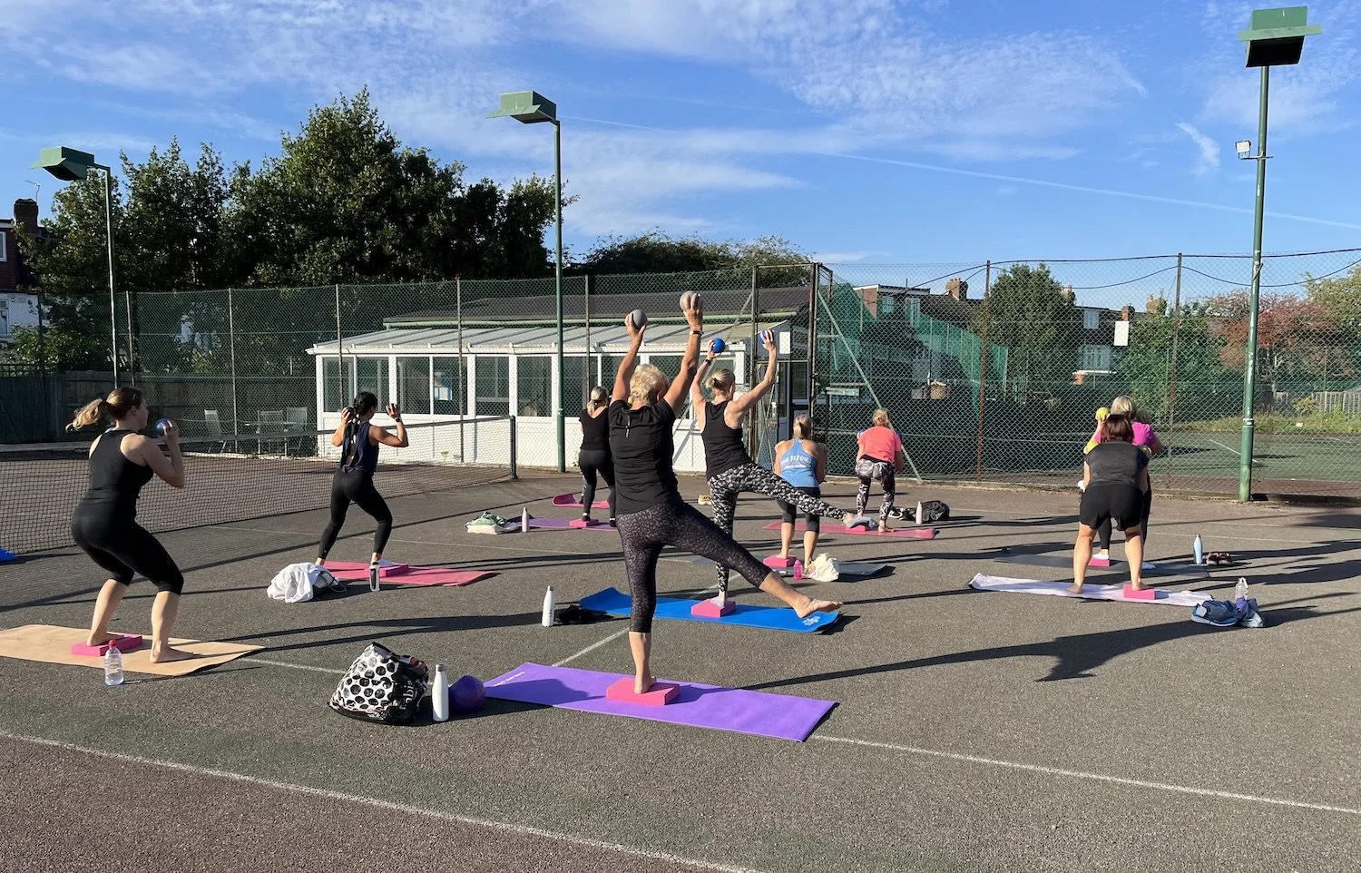 Ladies doing fitness classes outside with equipment