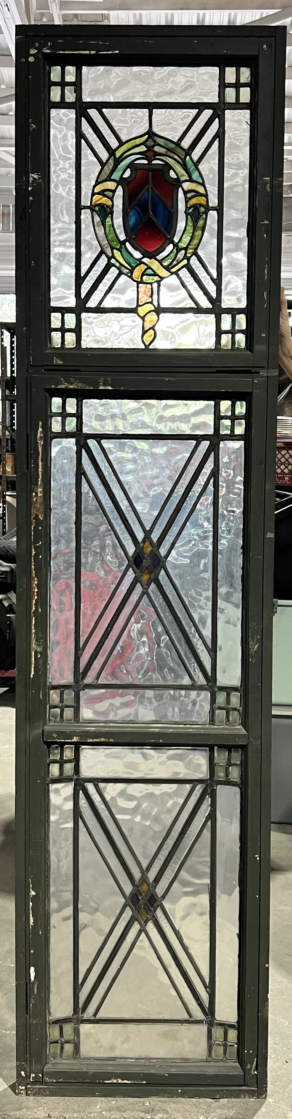 Tall stained glass window w/ crest