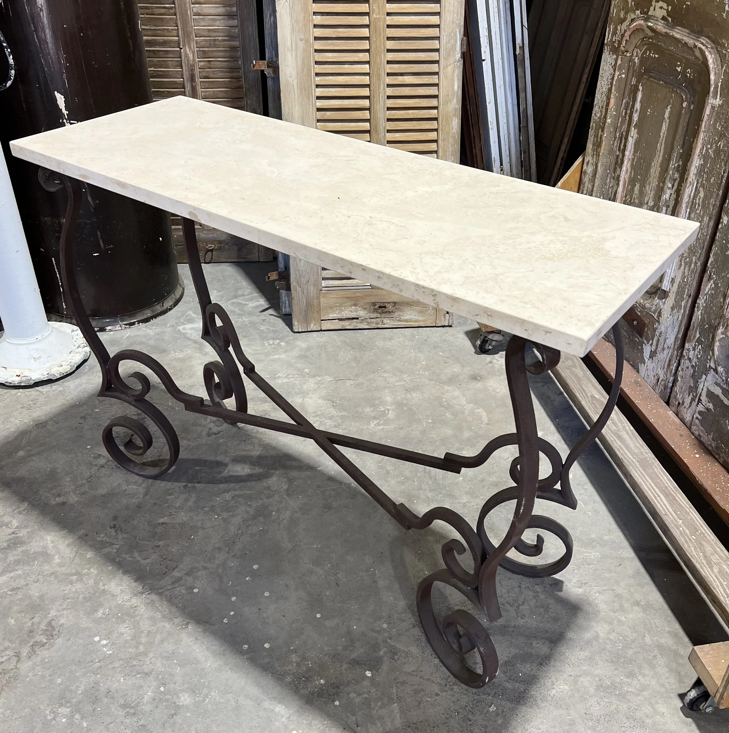 Travertine slab table on iron base