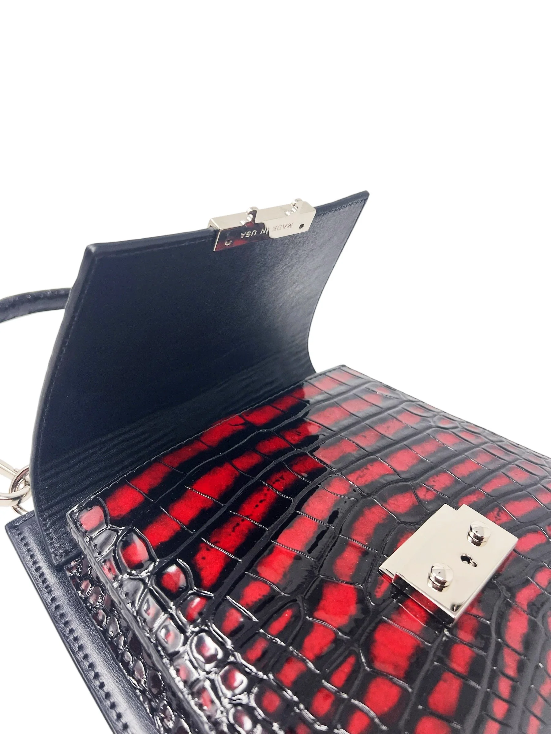 Betty Sanguine open, showing the black Italian lambskin lining and the red alligator scale pattern