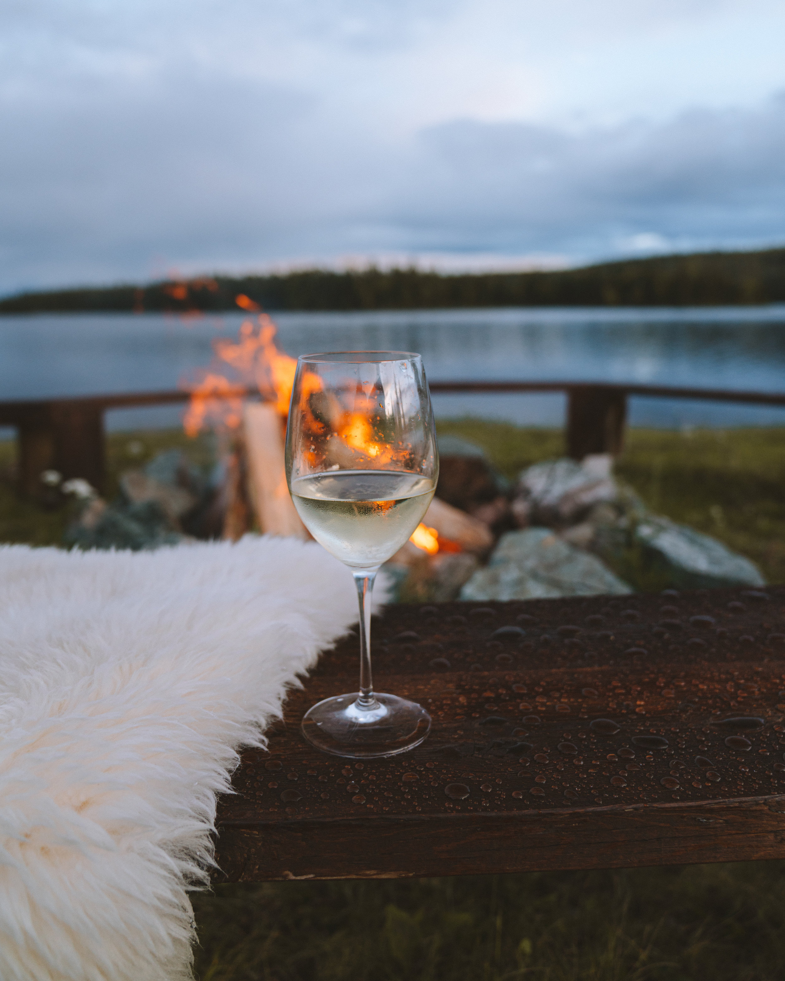 A glass of wine next to the fire at Batnuni Lake Resort