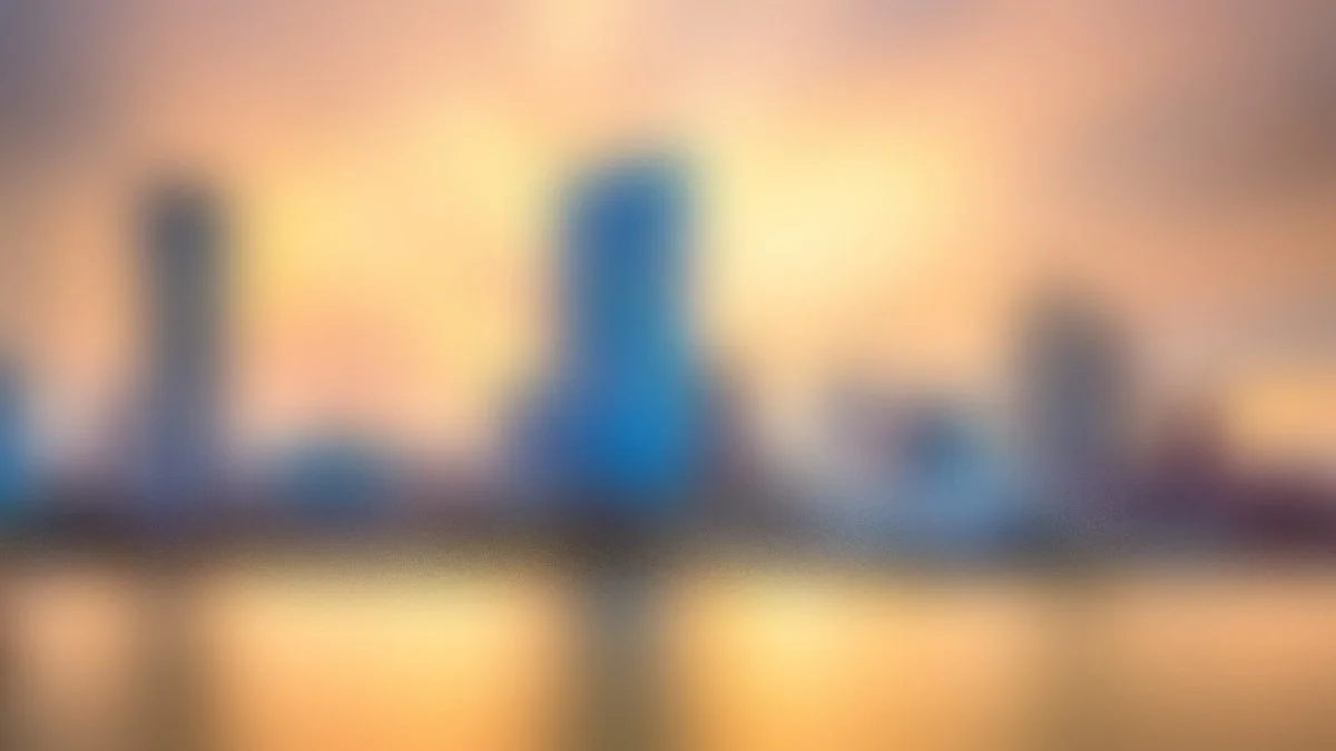 Nighttime city scene with a historic building, busy highway with streaks of light from moving vehicles, and a dark sky.