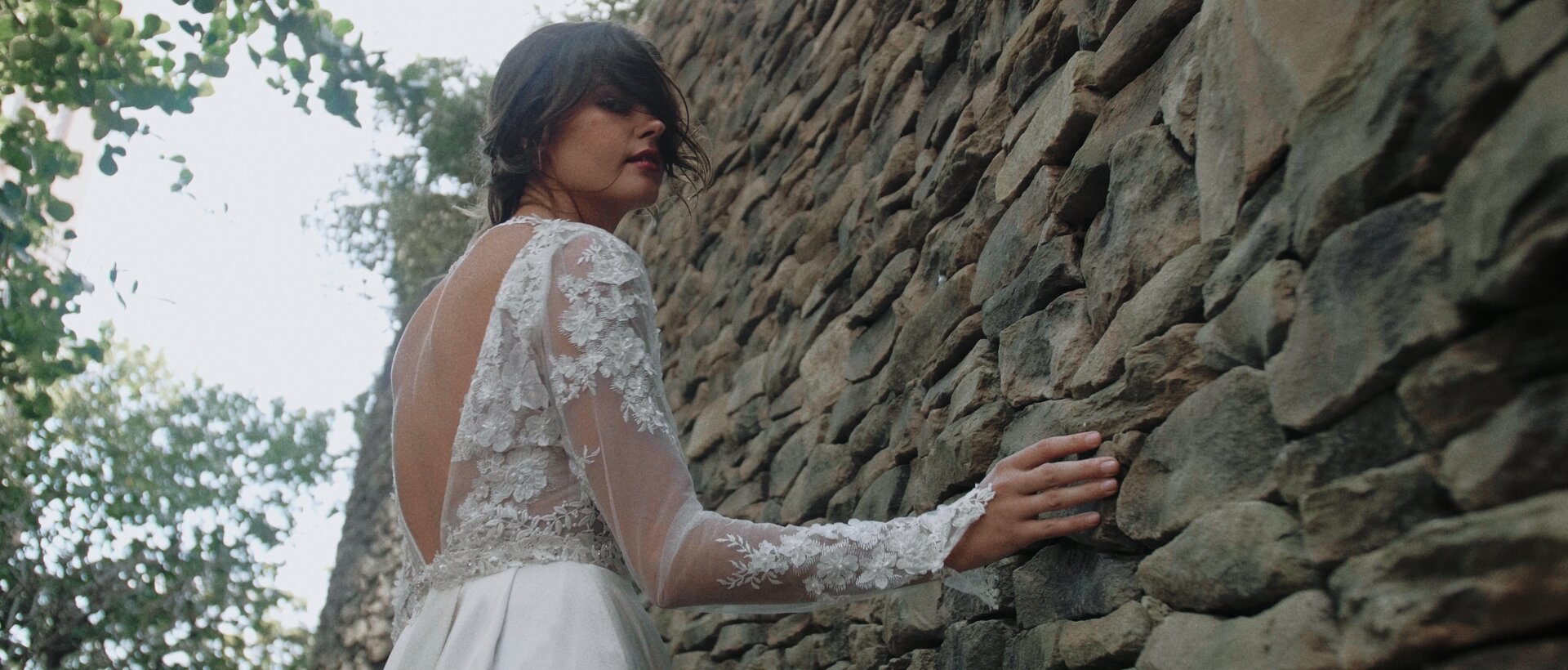 bride walking by Montage Kapalua stone wall luxury wedding