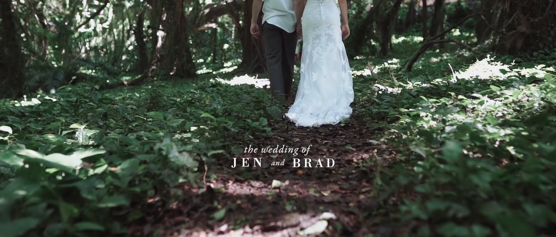 bride and groom walking in dress at the honolua bay forest