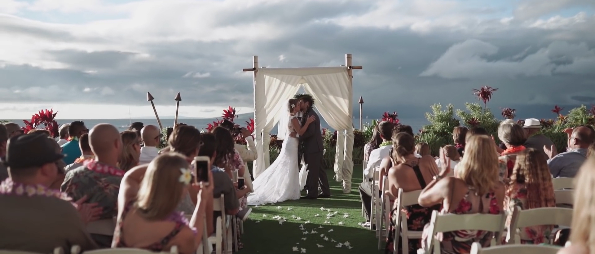 bride and groom kiss in royal lahaina ceremony site