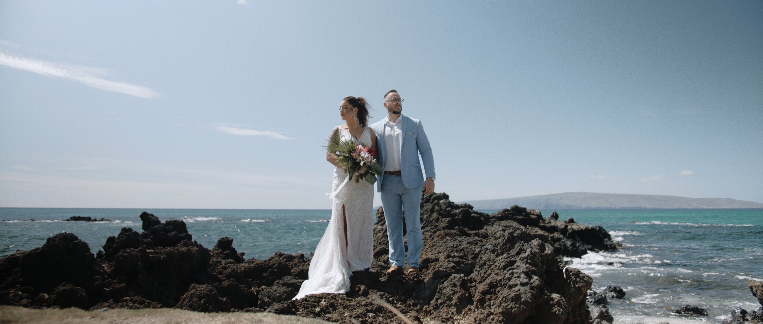 Bride and groom over lava rocks, wedding in hawaii