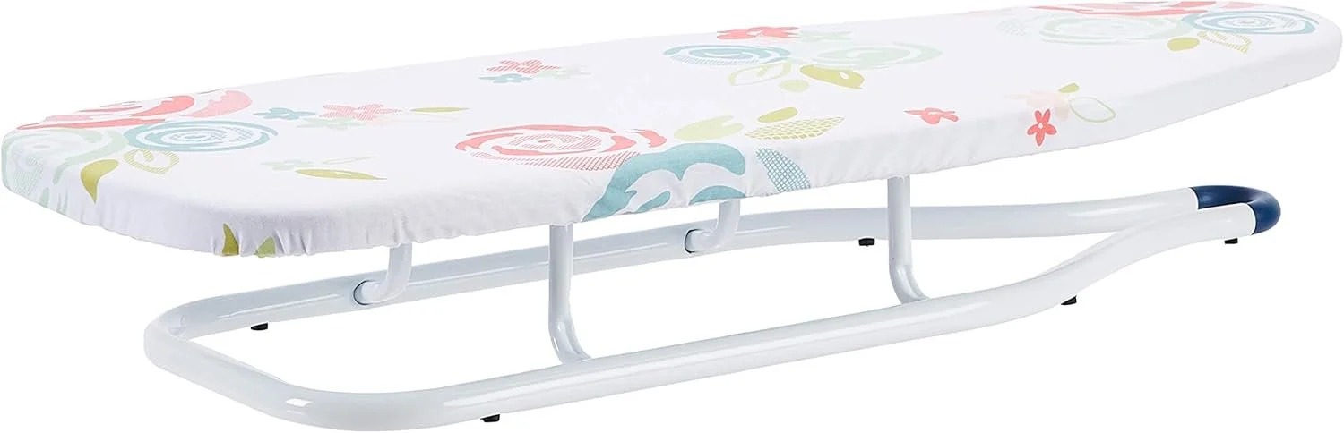A white metal-framed roller sled with a padded, floral-printed cushion on top.