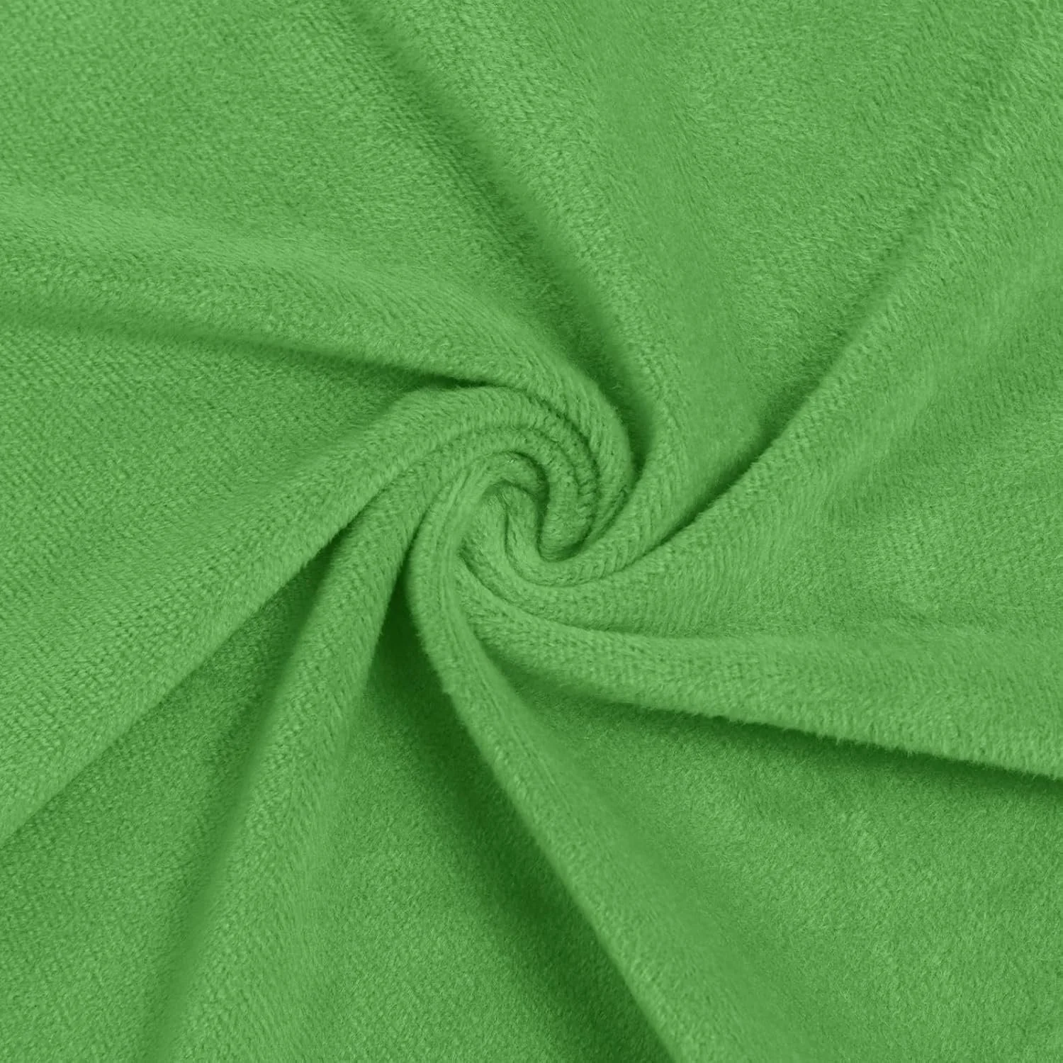 Close-up of bright green fabric twisted in a spiral, showing its textured surface.