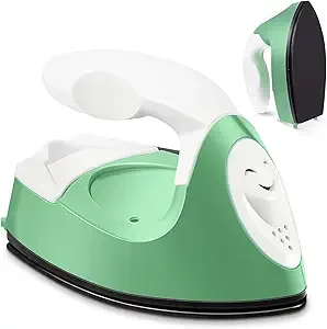 A handheld steam iron resting on a green and white ironing board.