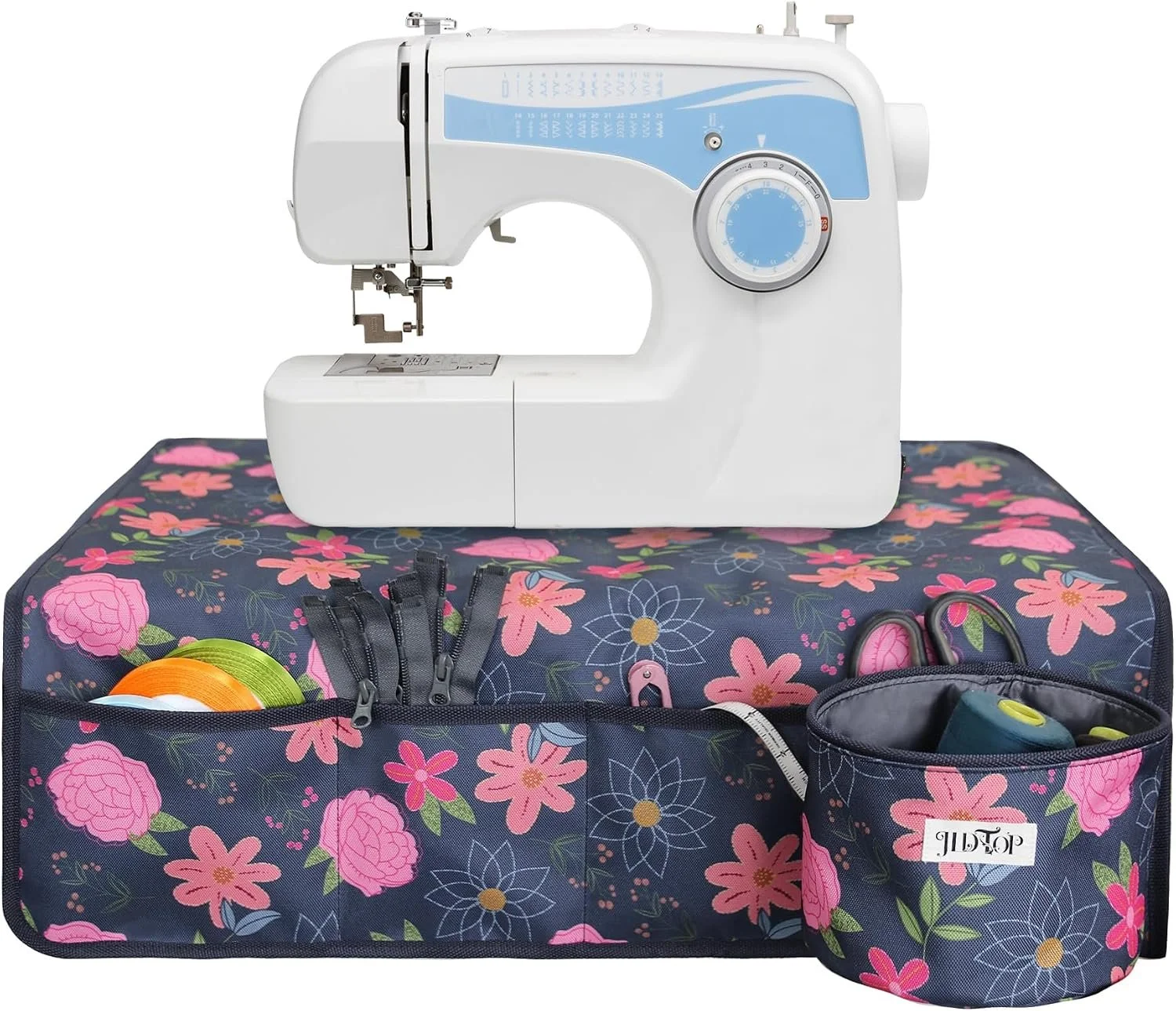 A sewing machine on floral fabric with sewing tools in zippered pouches.
