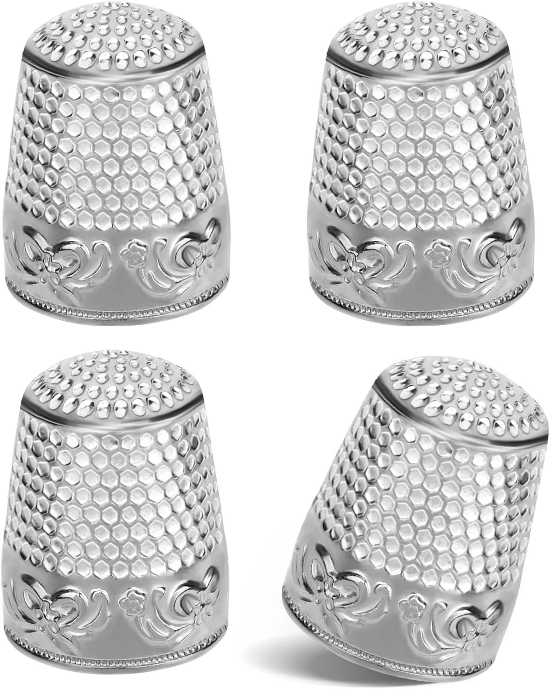 Set of four silver thimbles with decorative patterns, three upright and one tilted.