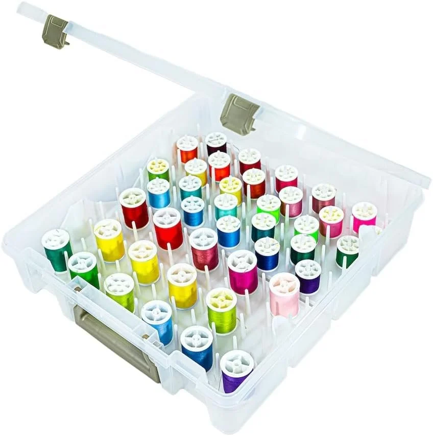A clear plastic storage box containing multiple spools of colorful sewing thread.
