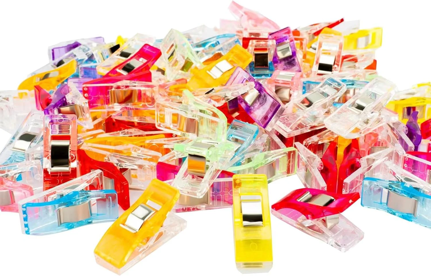 Colorful plastic clips scattered on a white surface.