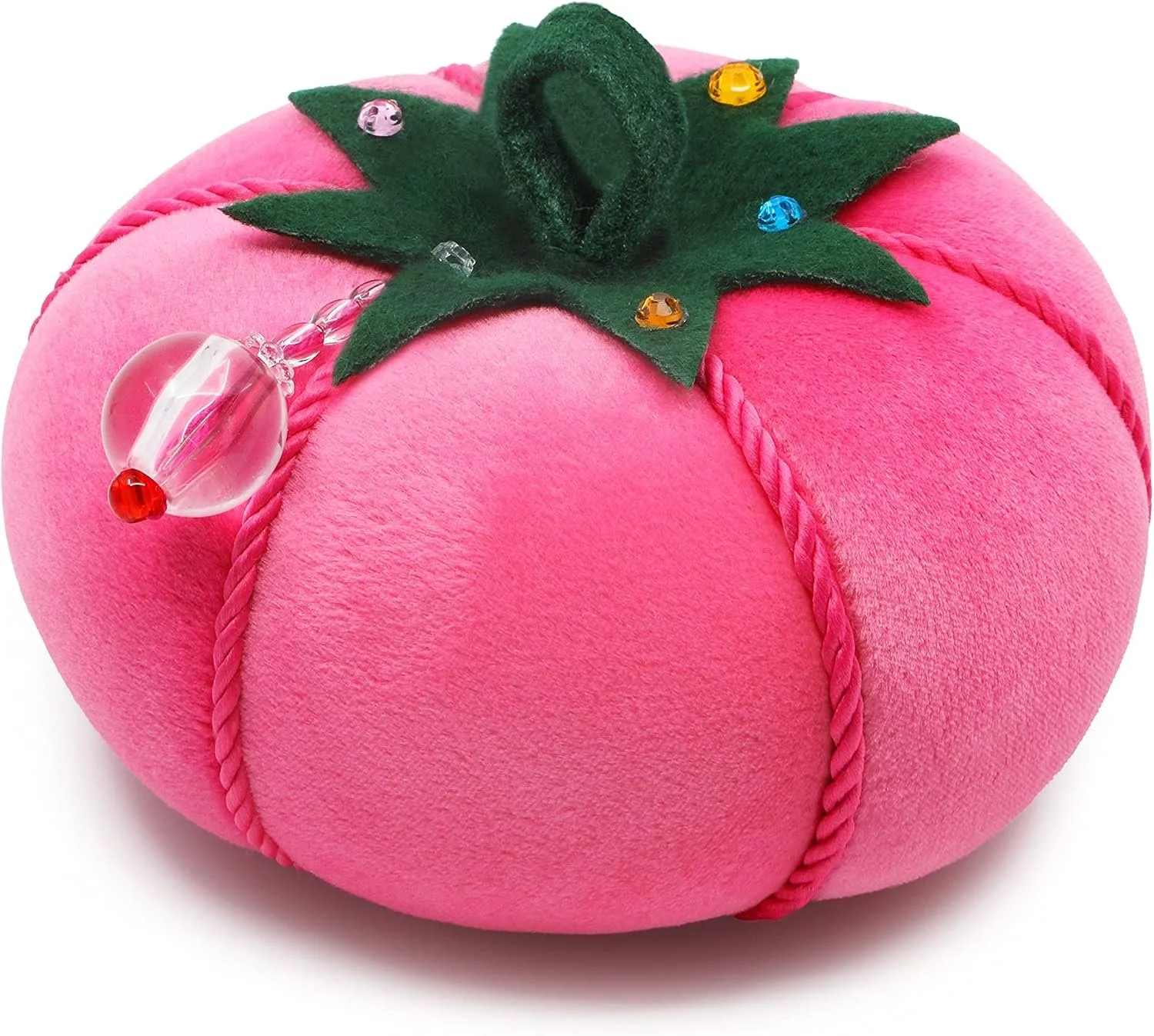 Pink plush strawberry-shaped cushion with green felt leaves and small colorful plastic jewels, with a glass drop-shaped ornament attached to a pink beaded chain.