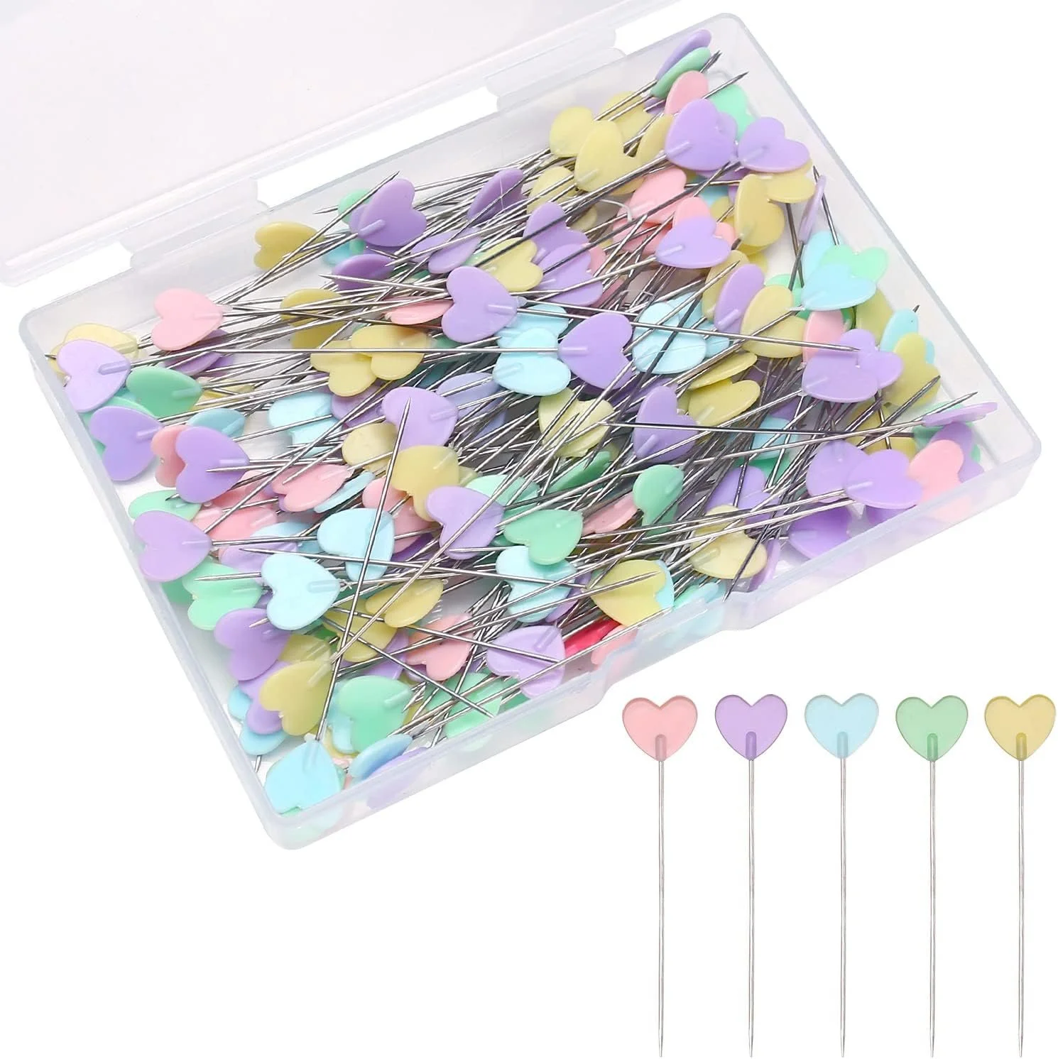 A clear plastic box filled with pastel-colored heart-shaped sewing pins with silver shafts, with a few pins laid out in front of the box.