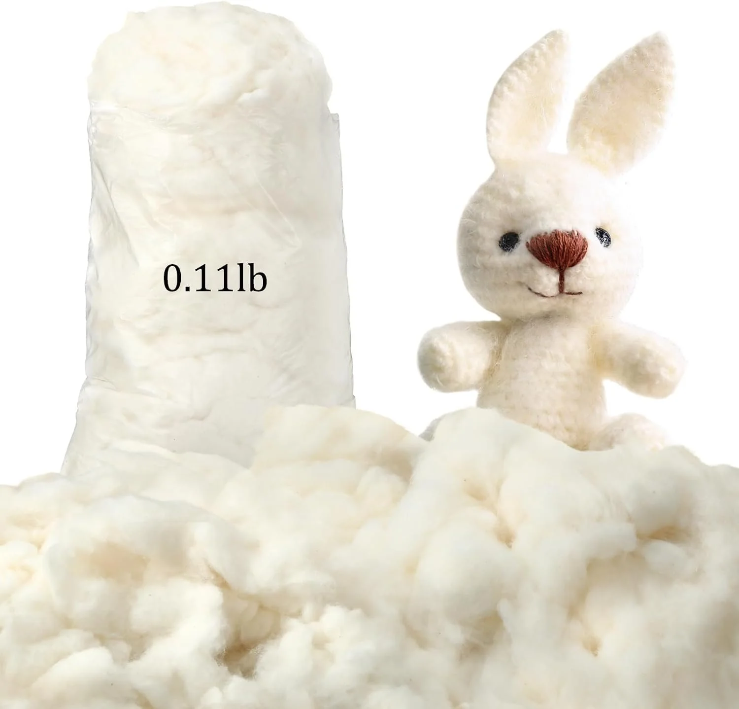A plush white bunny toy with long ears, a pink nose, and black eyes, standing among cotton balls. Behind the bunny, there's a clear plastic bag filled with cotton, labeled "0.11 lb."