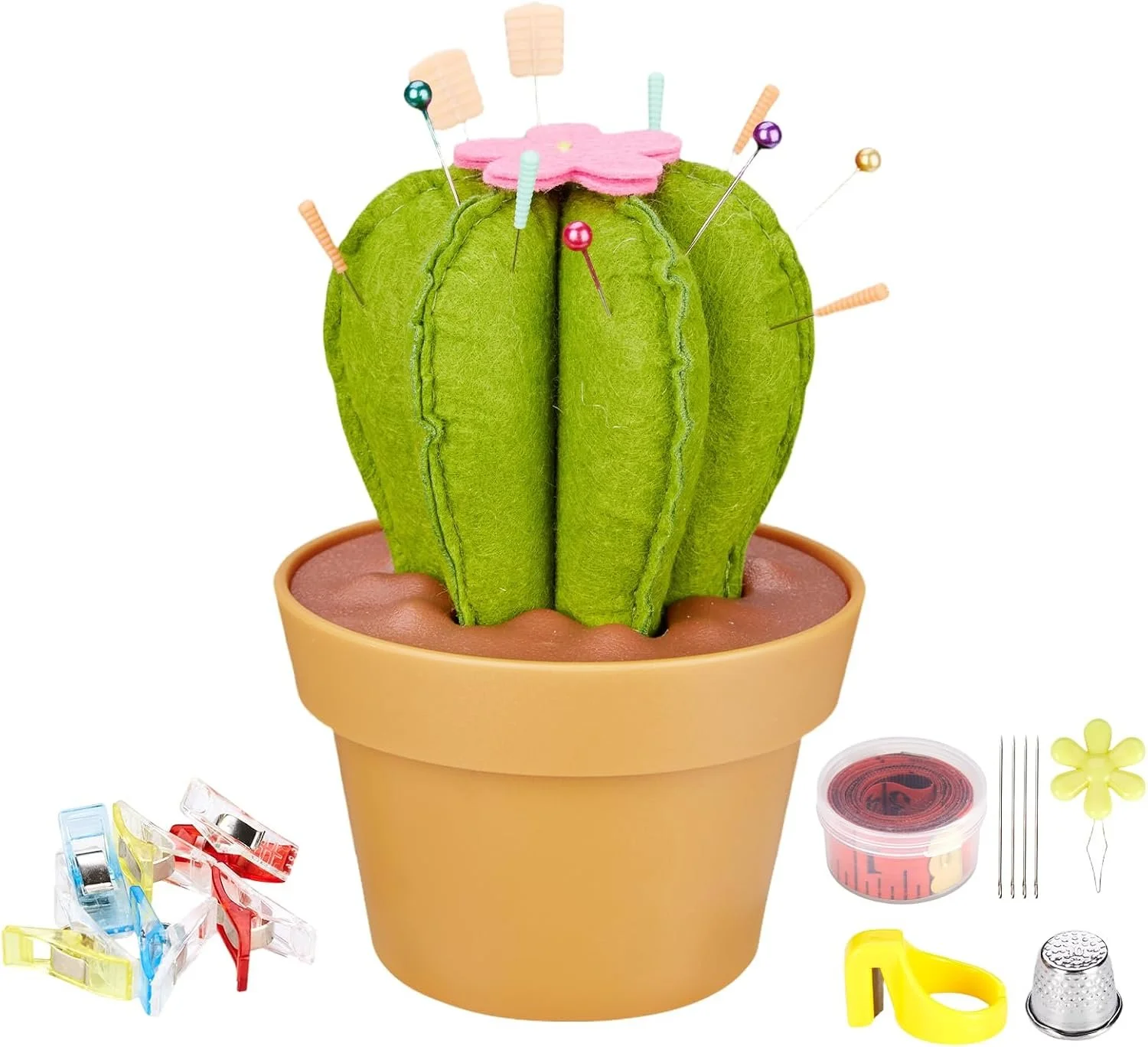 A felt cactus plant in a terracotta pot with sewing pins and accessories around it.