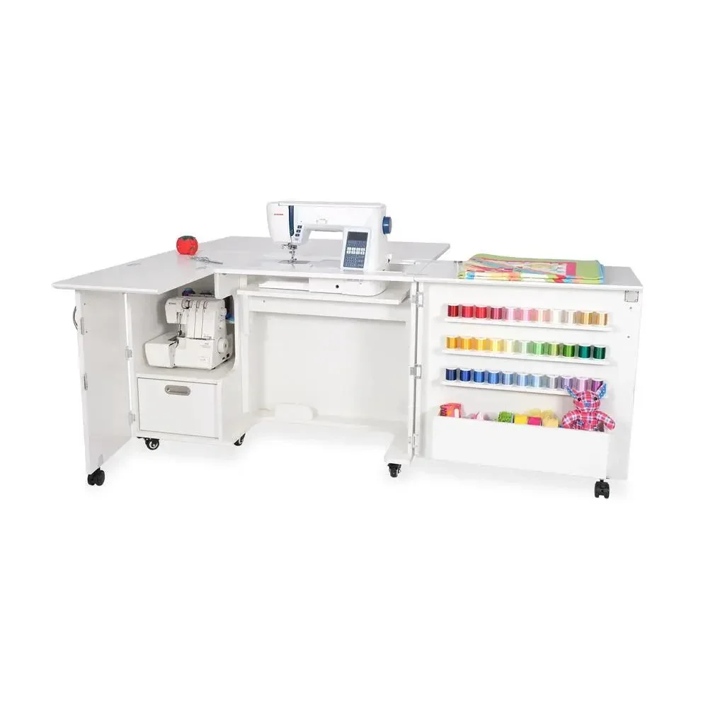 A white sewing craft station with a sewing machine, spools of thread, colorful fabric, and sewing accessories.