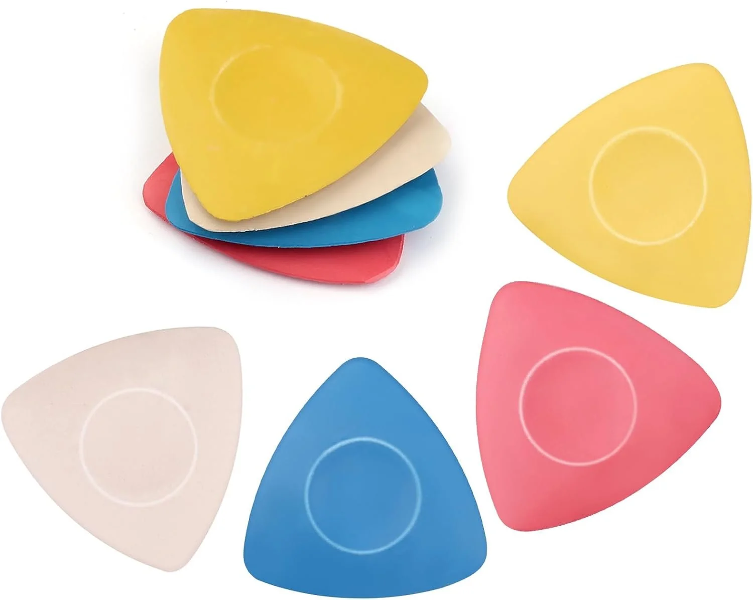 Colorful guitar picks in yellow, white, blue, and pink scattered on a white background, with some stacked.