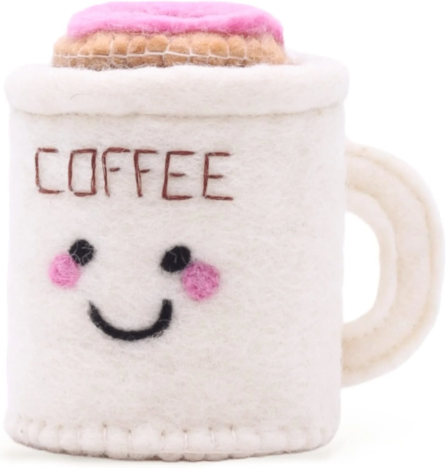 A white coffee mug with a smiley face, pink cheeks, and the word 'COFFEE' embroidered on it, with felted pink and brown pastries on top.