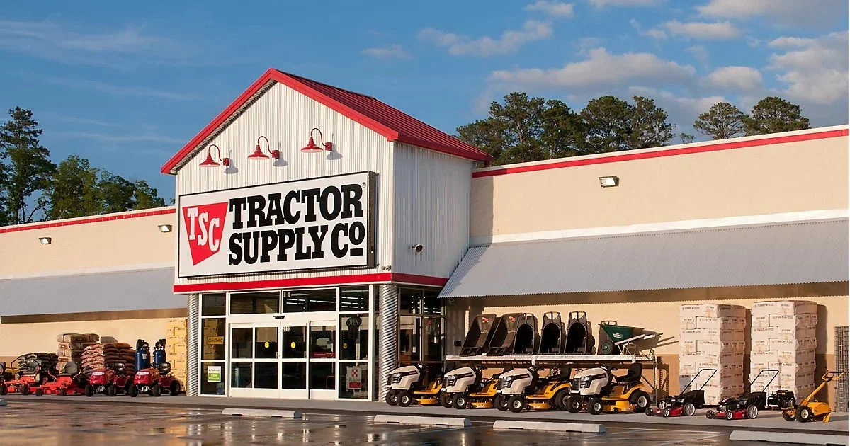 Exterior of Tractor Supply Co. store with lawn equipment and bags of soil outside