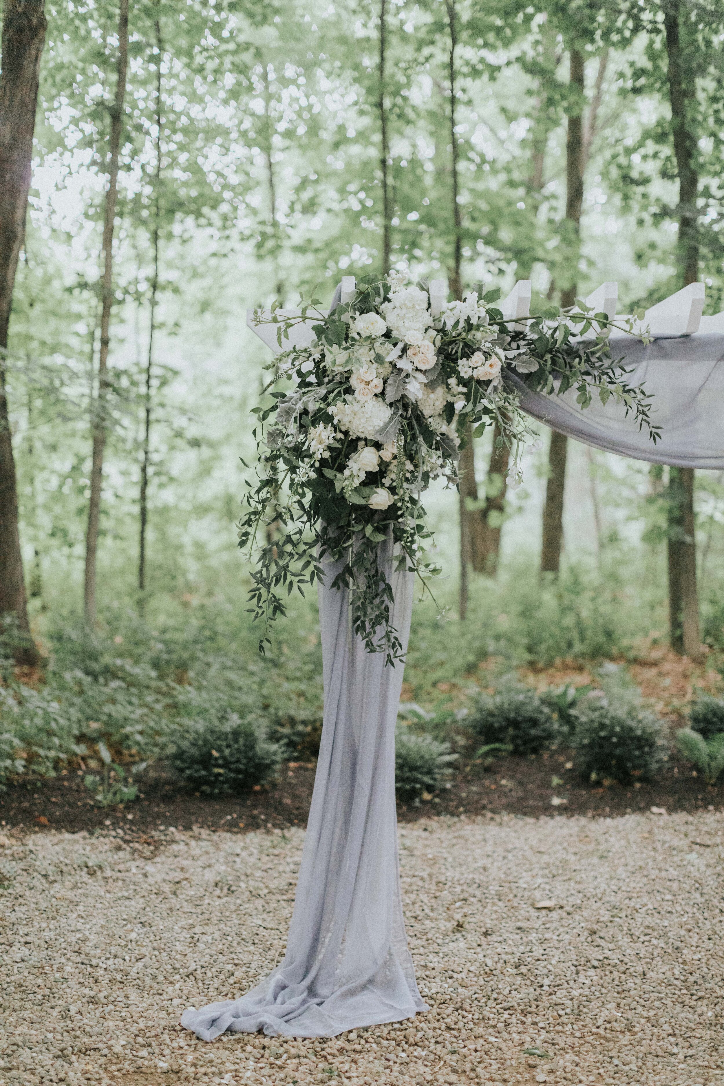 floral arrangement on outdoor wedding ceremony arch