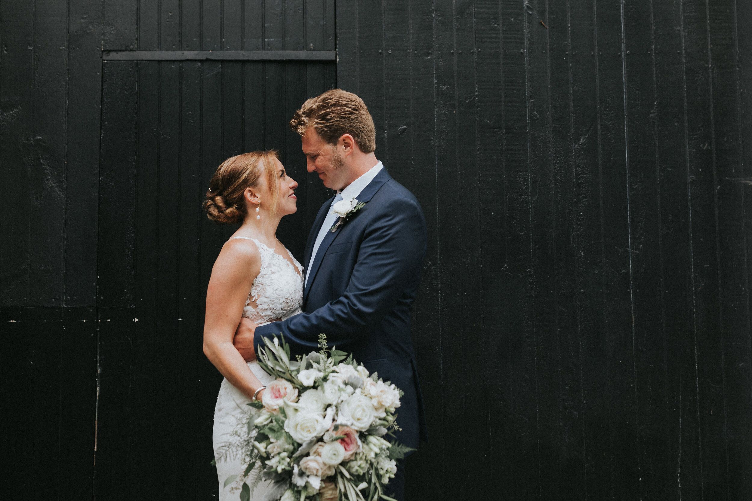 bride and groom first look portrait in front of wedding venue