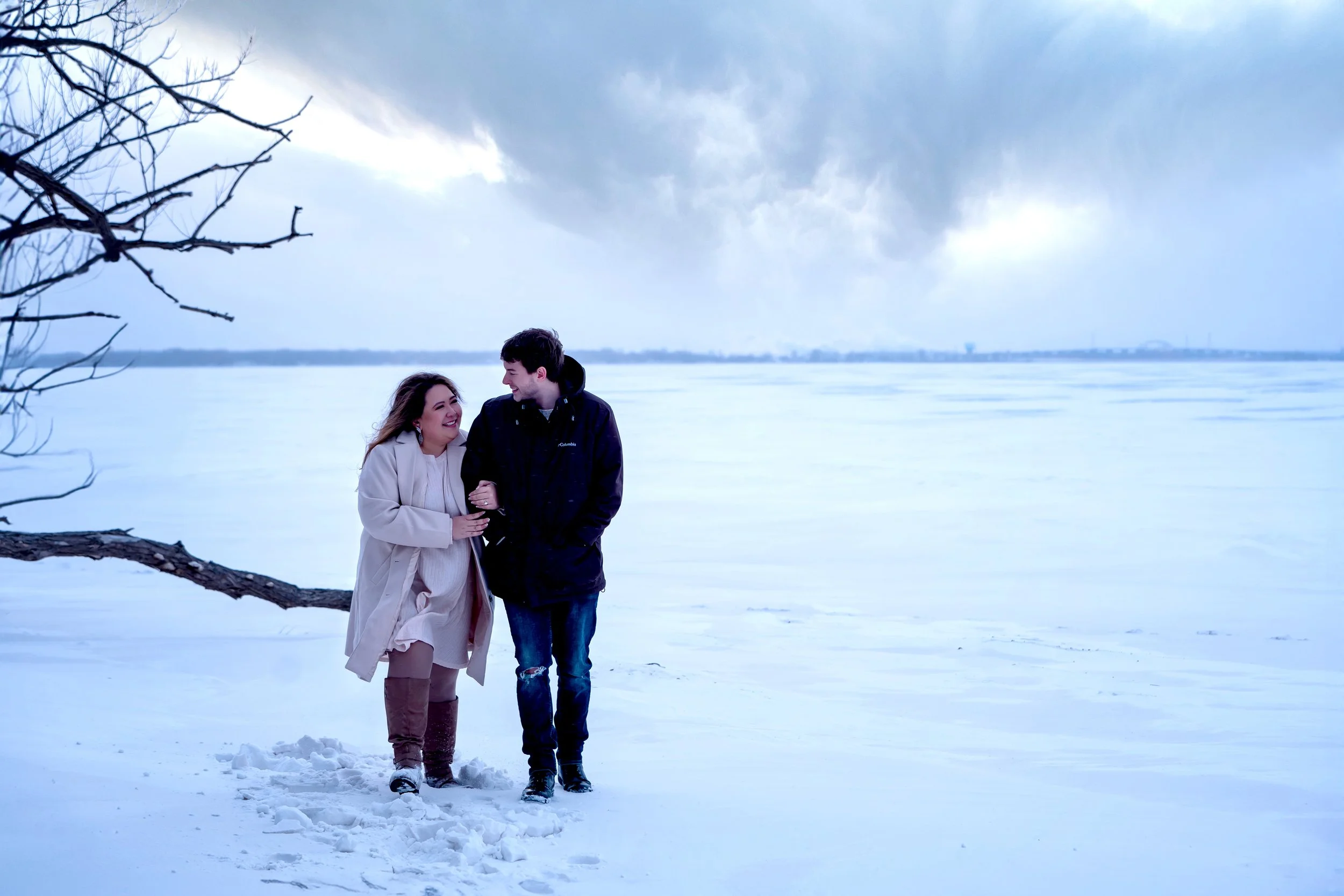 Winter engagement photos on frozen Lake Michigan shoreline in Wisconsin