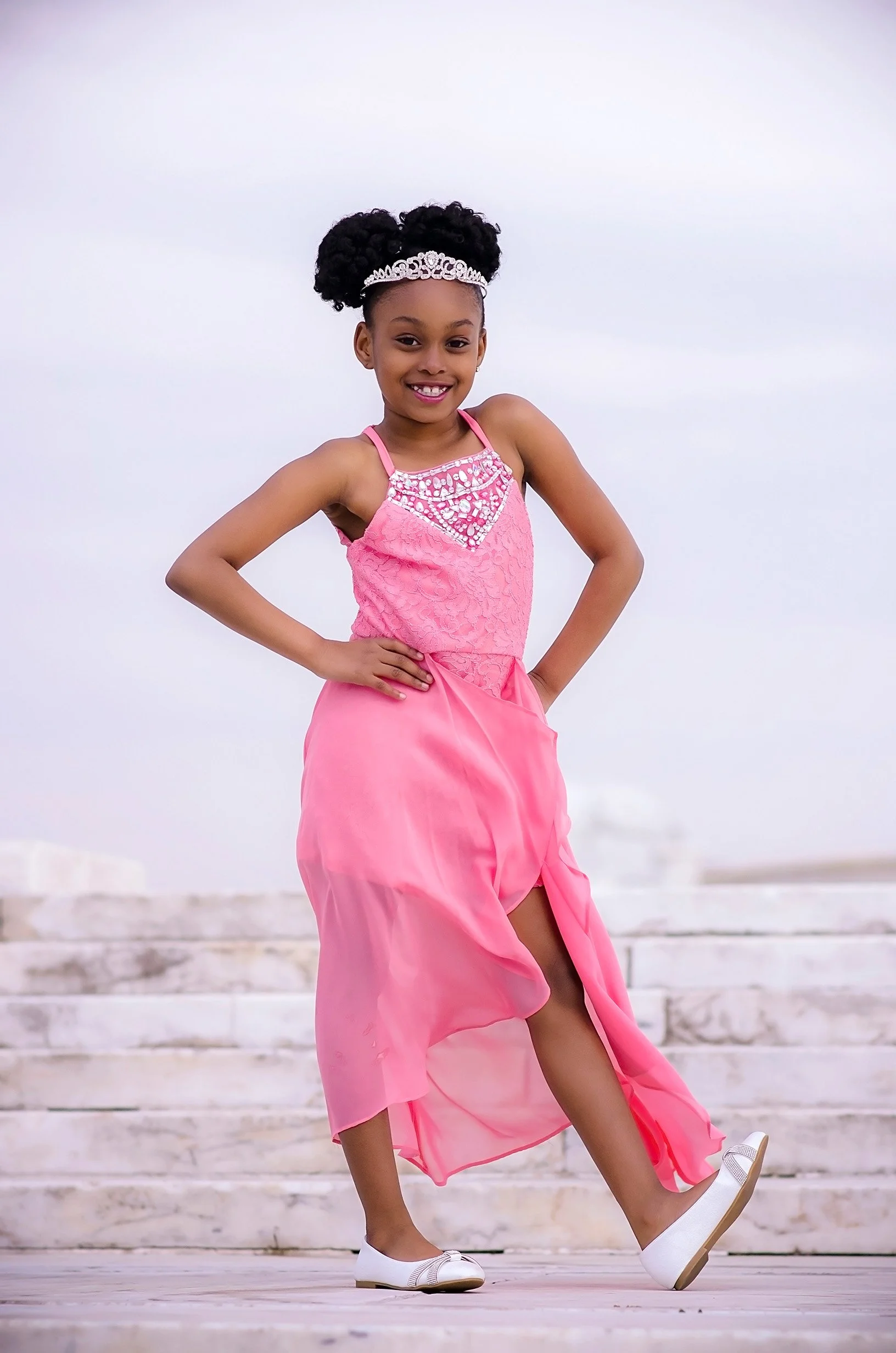 Black child model in pink dress and tiara in Detroit
