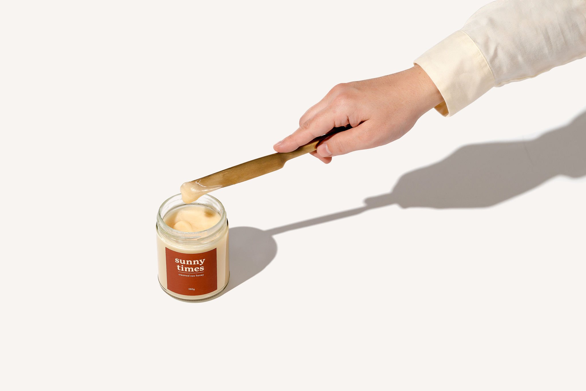 Jar of Sunny Times Certified Organic raw creamed honey, jar with smooth, spreadable creamed honey