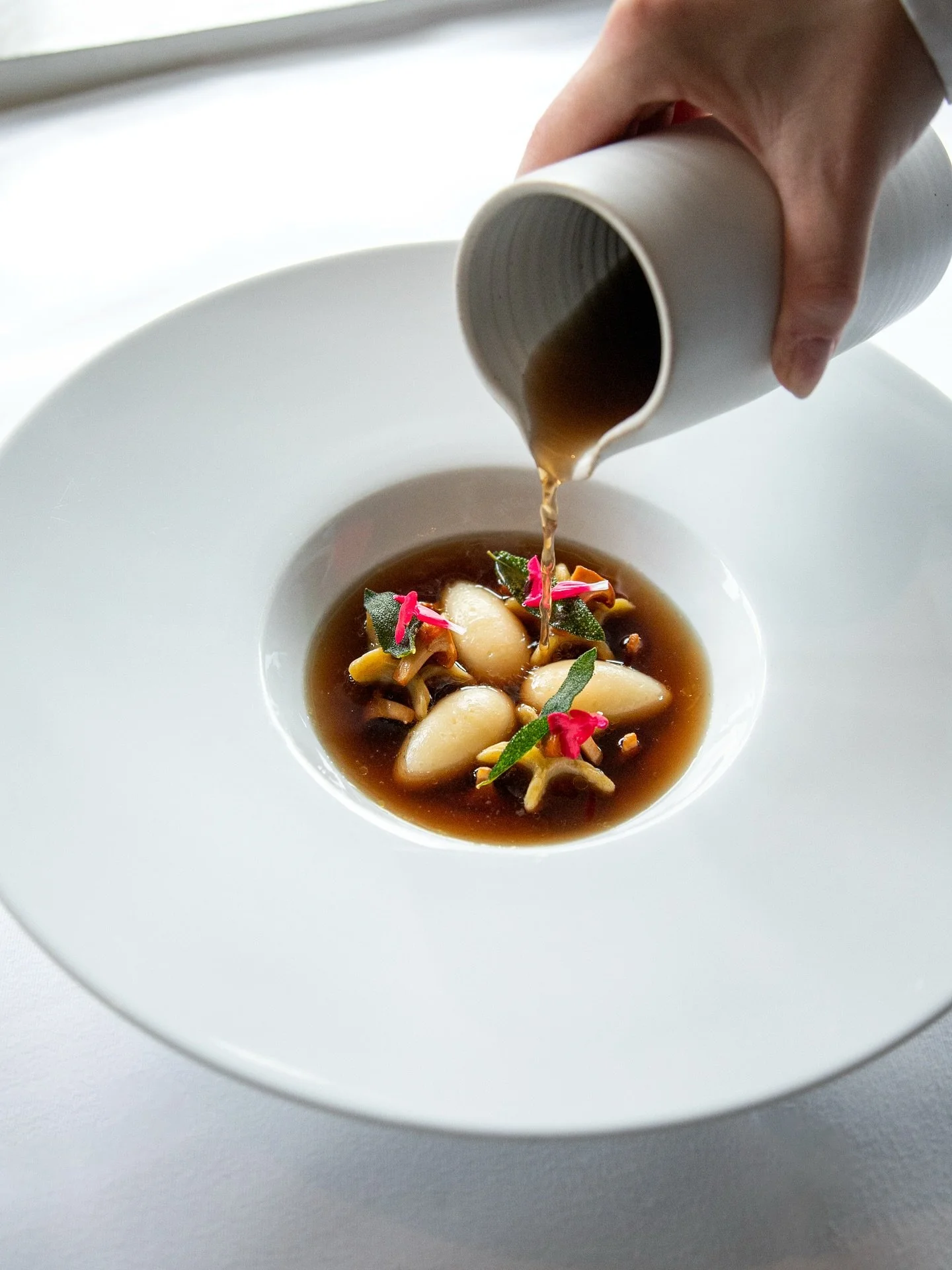 Scallop quenelle with truffle bouillon, chanterelles and pasta girasole - available à la carte or as part of our tasting menu at Krogs Fiskerestaurant.