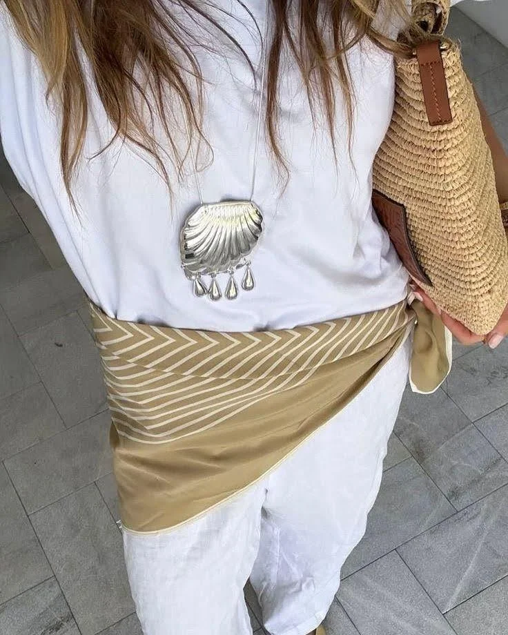 woman's outfit photo wearing white tshirt shell necklace and silk scarf belt