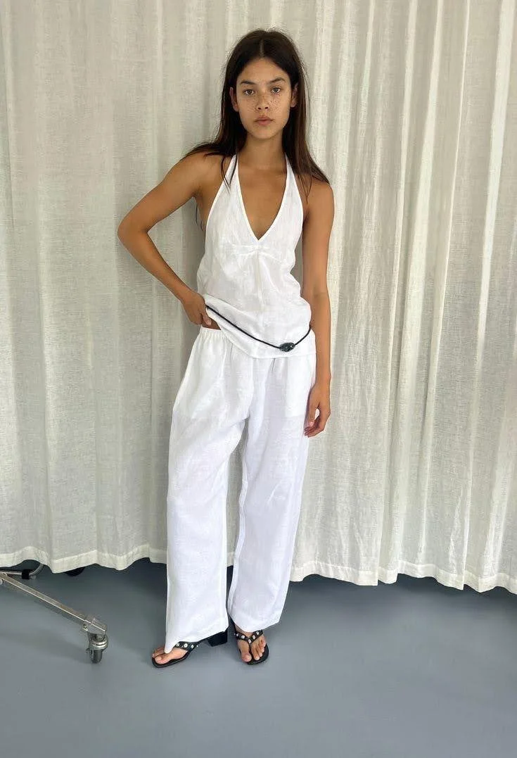 girl wearing white linen two piece set halter top and pants