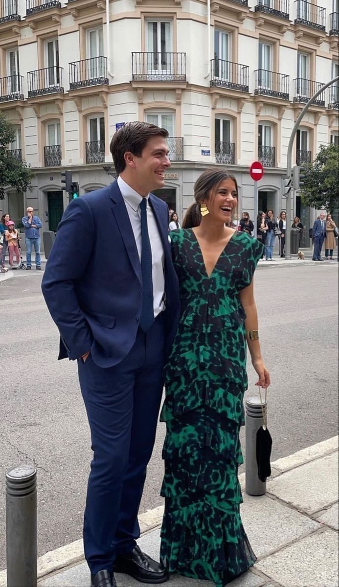 couple at wedding in a maxi green dress and blue suit