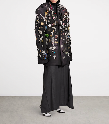 Close-up of a decorative brooch pinned on a jacket, showing intricate design and detail