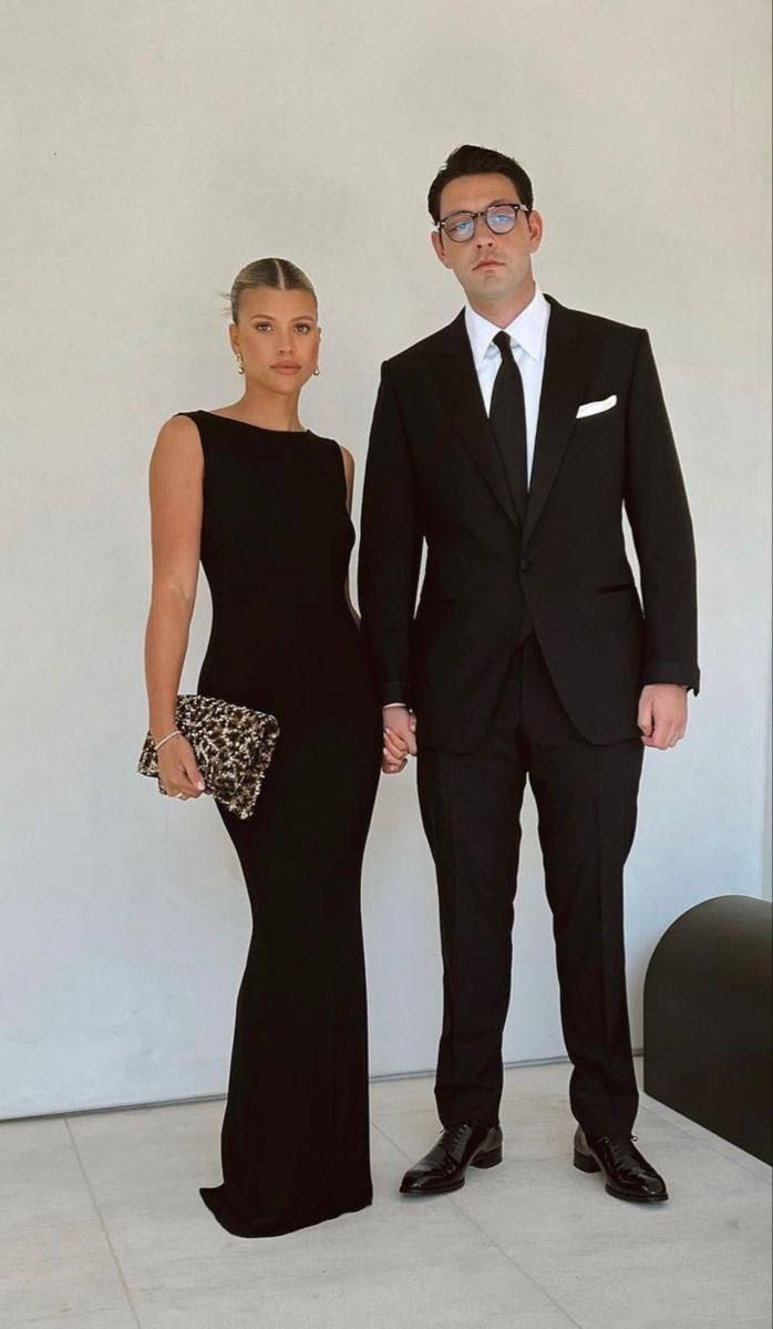 sofia grange and husband elliot wearing black tie and maxi black dress